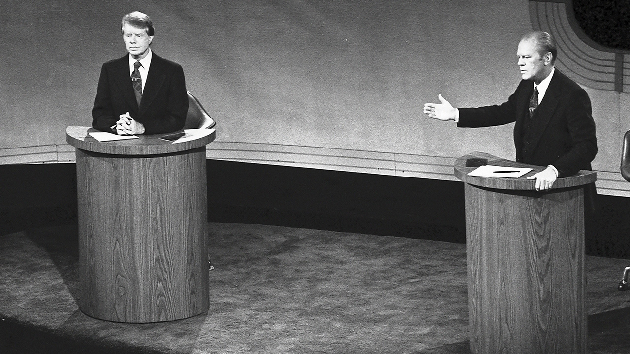 Jimmy Carter and Gerald Ford take part in the first televised debate between candidates for the President of the United States during the 1976 election.